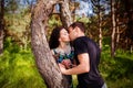 Young couple kissing outdoor in summer sun light. Kiss love date color evening teen. Royalty Free Stock Photo