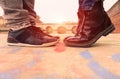 Young couple kissing outdoors - Lovers have hidden date at sunset in city - Close up on shoes - Love and romantic concept in Royalty Free Stock Photo