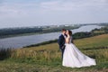 Young couple kissing outdoors on their wedding day Royalty Free Stock Photo