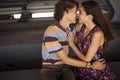 Young couple kissing in the summer daylight on a bridge construction in the city outdoors. copy space