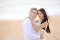 Young couple kissing at sunset on sandy beach Royalty Free Stock Photo