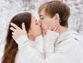 Young couple kissing in winter forest Royalty Free Stock Photo