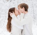 Young couple kissing in winter forest Royalty Free Stock Photo