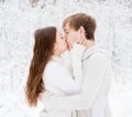 Young couple kissing in winter forest Royalty Free Stock Photo