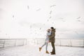 young couple kissing on winter quay