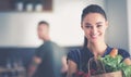 Young couple in the kitchen , woman with a bag of groceries shopping Royalty Free Stock Photo