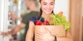 Young couple in the kitchen , woman with a bag of groceries shopping Royalty Free Stock Photo