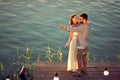 Young couple on the lake watching a beautiful sunset Royalty Free Stock Photo