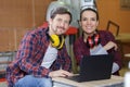 young couple with laptop in carpenter workroom Royalty Free Stock Photo