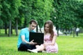 Young couple with laptop in park