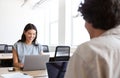 Young couple with laptops at desks working on start up business in rented open plan office space Royalty Free Stock Photo