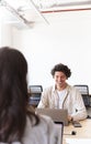 Young couple with laptops at desks working on start up business in rented open plan office space Royalty Free Stock Photo