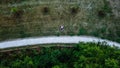 Young couple laying on the grass, drone photo, aerial perspective, bird`s eye view