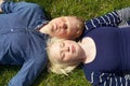 Young couple laying on grass side by side Royalty Free Stock Photo