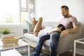 Young couple laying on the sofa relaxing at home