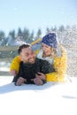 Young couple lies on snow.