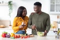 Young Couple Lifestyle. Happy Black Man And Woman Spending Time In Kitchen Royalty Free Stock Photo