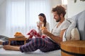 A young couple likes to have a breakfast in the bed. Love, relationship, together Royalty Free Stock Photo