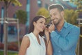 Young couple listening music in city by headphones outdoors Royalty Free Stock Photo