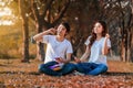 Couple listening music from mobile with headphone in the park Royalty Free Stock Photo