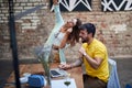 Young couple listening music together with one headphones, singing at public place, having fun Royalty Free Stock Photo