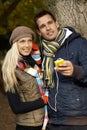 Young couple listening to music outdoors smiling Royalty Free Stock Photo