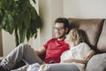 Couple watching TV on a sofa at home