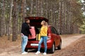Young couple loading suitcases into car trunk Royalty Free Stock Photo