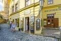 A young couple look in the window of a marionette and puppetry shop on Kampa Island in Prague, Czechia