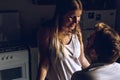 Young couple looking at each other and kissing in the kitchen happy Royalty Free Stock Photo