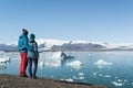 Young couple looking at Jokulsarlon glacier lake in Iceland