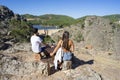 young couple looking at the landscape of the dam in the Portuguese village of Penha Garcia