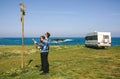 Young couple looking a map and direction sign Royalty Free Stock Photo