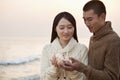 Young Couple Looking At a Seashell Royalty Free Stock Photo