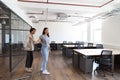 Young couple looking at work space for start up business to rent walking into open plan office Royalty Free Stock Photo