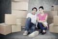 Young couple looks tired after unpacking cardboard