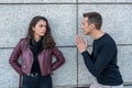 A young couple in love during an argument, he tries to apologize with his hands to prayer