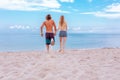 Young couple in love at beach and enjoying time being together, running on the beach Royalty Free Stock Photo