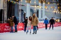 Young couple in love Caucasian man with blond hair with long hair and beard and beautiful woman have fun, active date skating on i