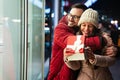 Young couple in love is celebrating with gift. Christmas birthday valentines day present concept Royalty Free Stock Photo