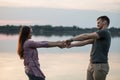 Young couple dancing on the beach, holding hands. Royalty Free Stock Photo
