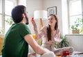 Young couple in love eating breakfast on bed indoors at home. Royalty Free Stock Photo