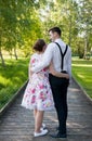 Young couple in love embrace. Long wooden path Royalty Free Stock Photo
