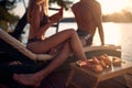 A young couple in love enjoying sun and fruits on the river bank. Summer, river, vacation Royalty Free Stock Photo