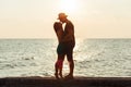 Young couple in love enjoying sunset on the beach Royalty Free Stock Photo