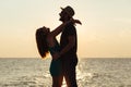 Young couple in love enjoying sunset on the beach Royalty Free Stock Photo
