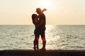 Young couple in love enjoying sunset on the beach Royalty Free Stock Photo