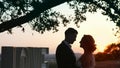 Young couple in love in evening dresses are standing near love light letters. Royalty Free Stock Photo