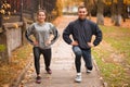 Young couple in love exercise in an autumn park. Do the attacks forward. Outside. Royalty Free Stock Photo