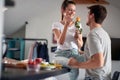 A young couple in love has a good time on Valentine`s day while having a breakfast at home. Love, together, breakfast, home Royalty Free Stock Photo